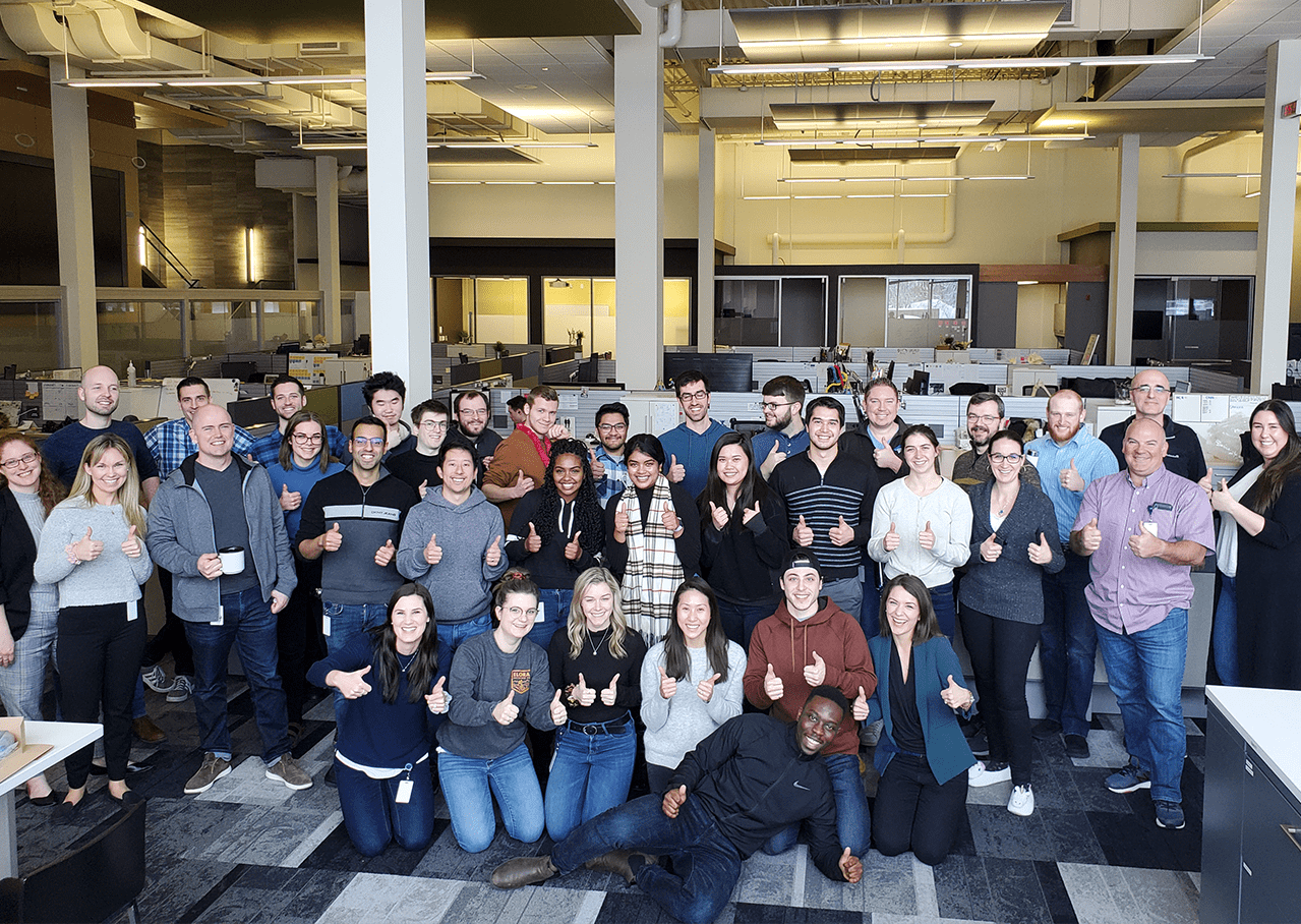 IJS Team Group photo of Intellijoint Surgical employee staff with thumbs up